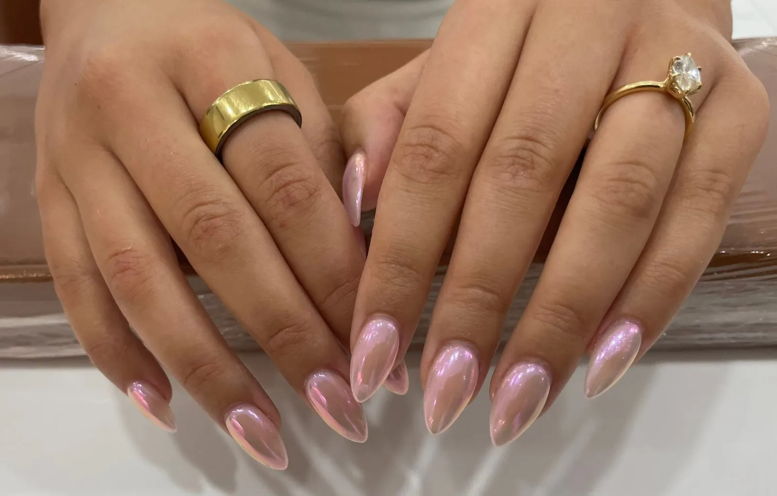 Long almond nails with a pale pink chrome finish