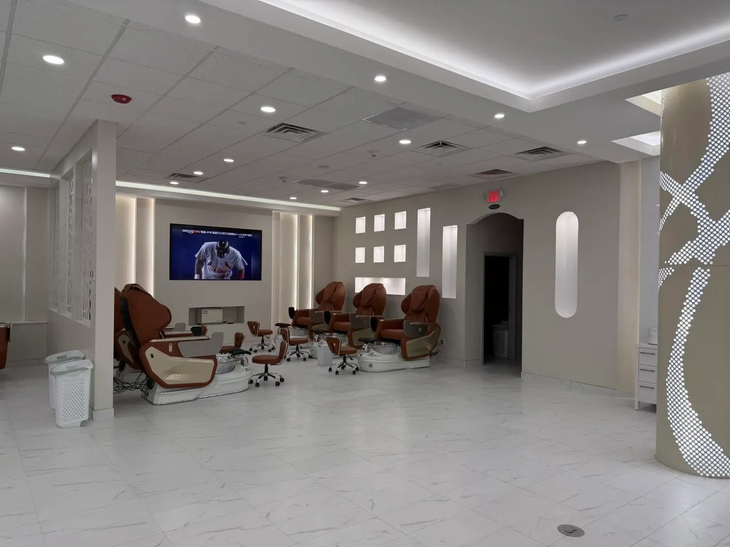 Massage pedicure chairs facing a TV on the wall